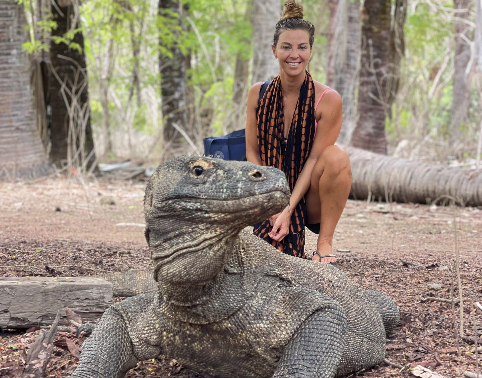 A tourist with the iconic komodo dragon