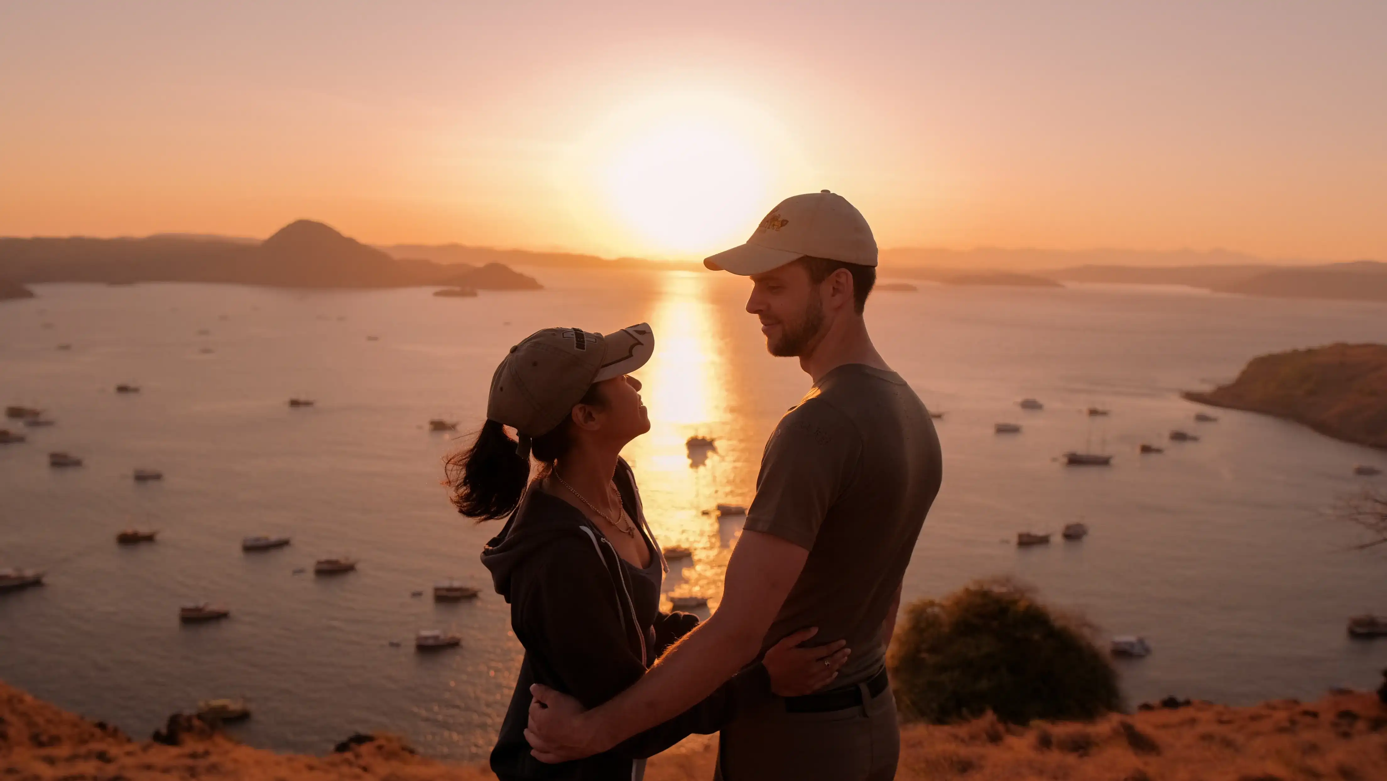 A couple at the Padar viewpoint at sunrise